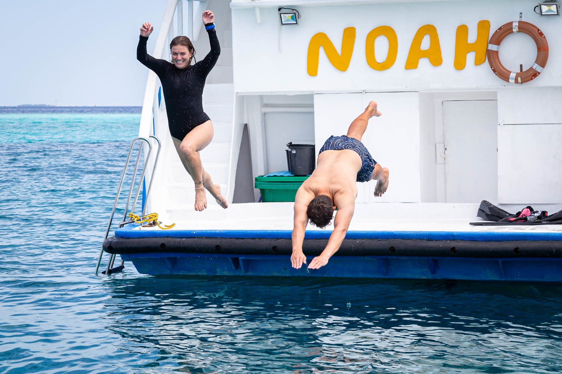 Guests jumping and back-flipping off NOAH's swim platform