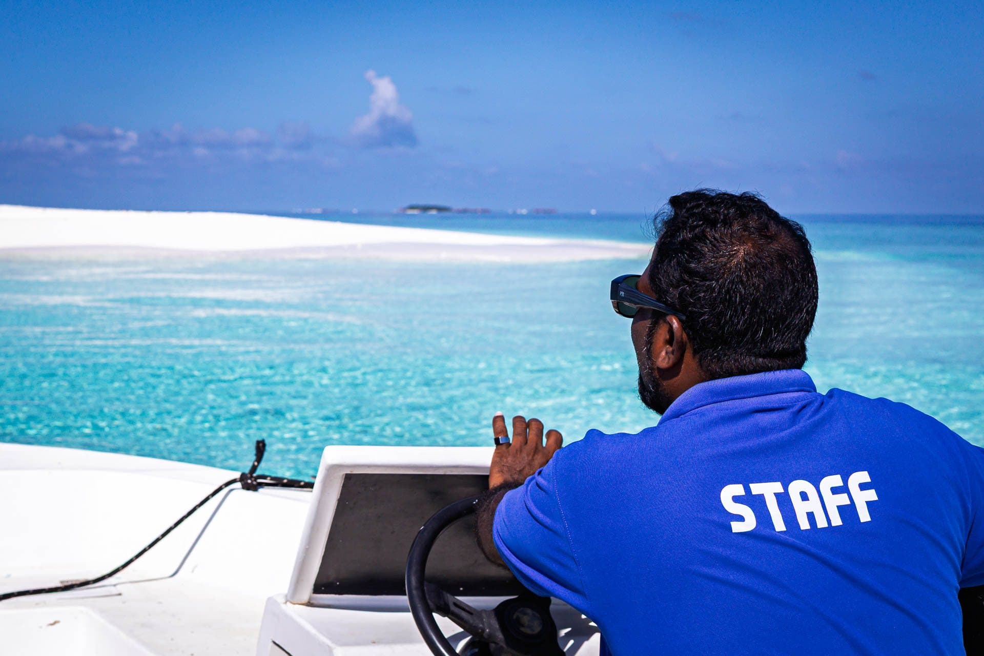Captain Sunil steering the dinghy towards a sandbank