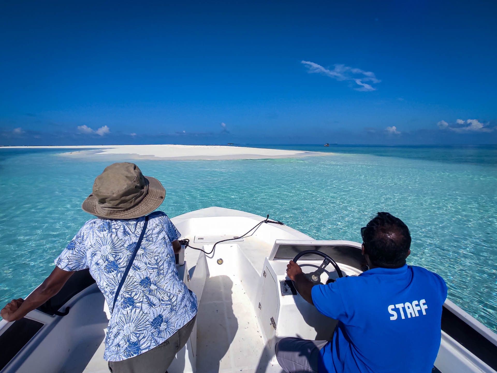 Captain Sunil taking a guest out to a sandbank by dinghy