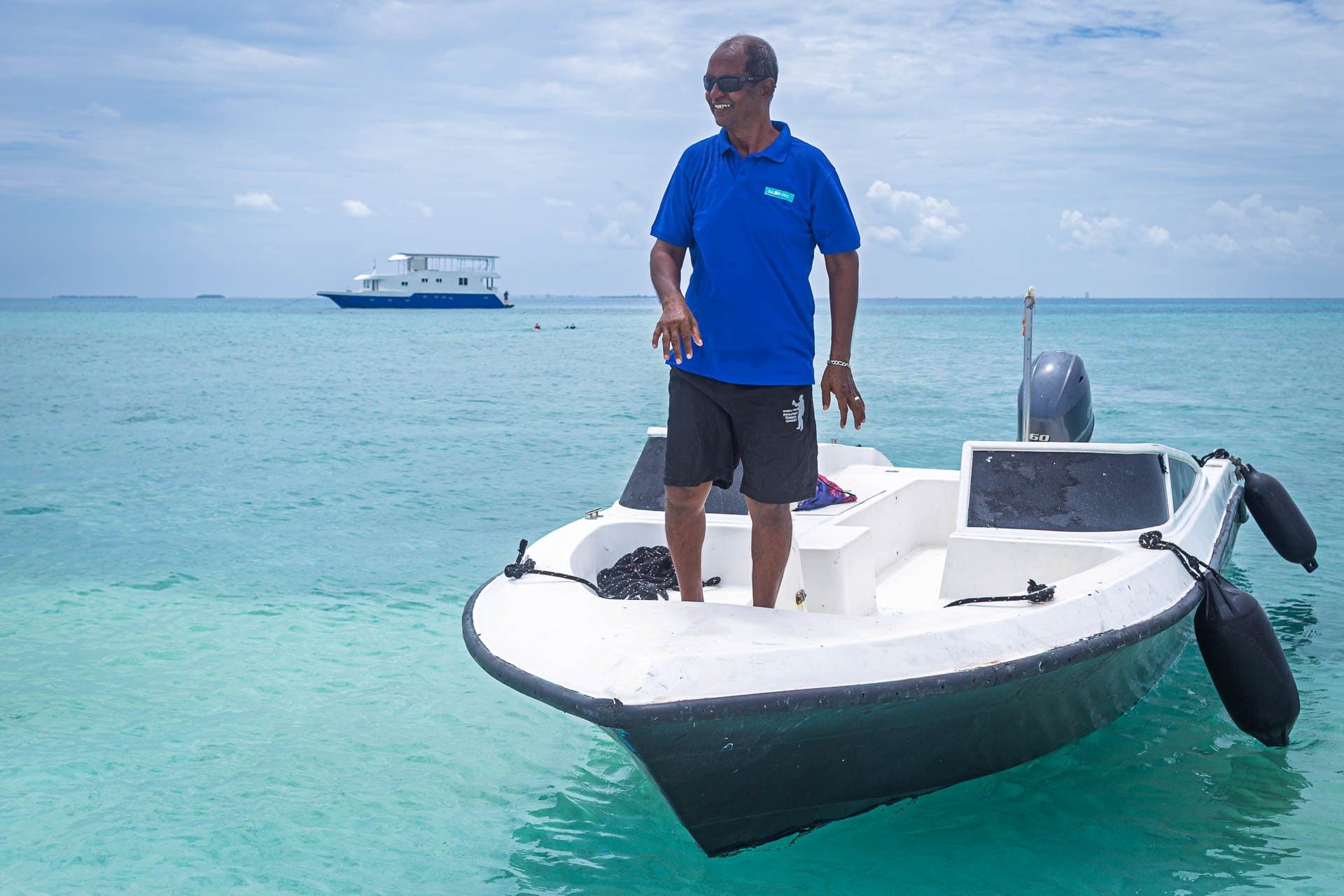 Crew member bringing the dinghy in at a sandbank