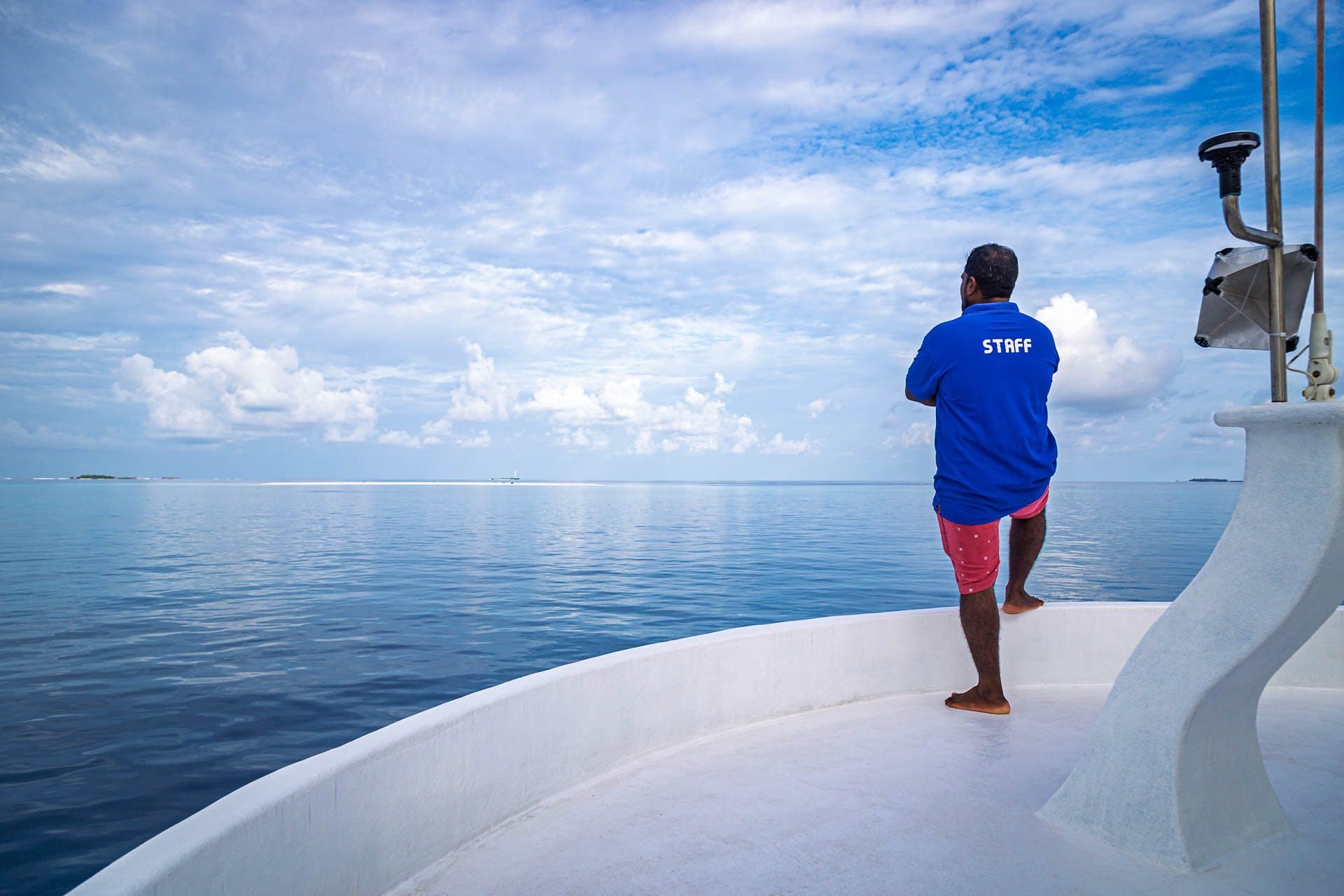 Crew member on NOAH's bow looking out over the lagoon