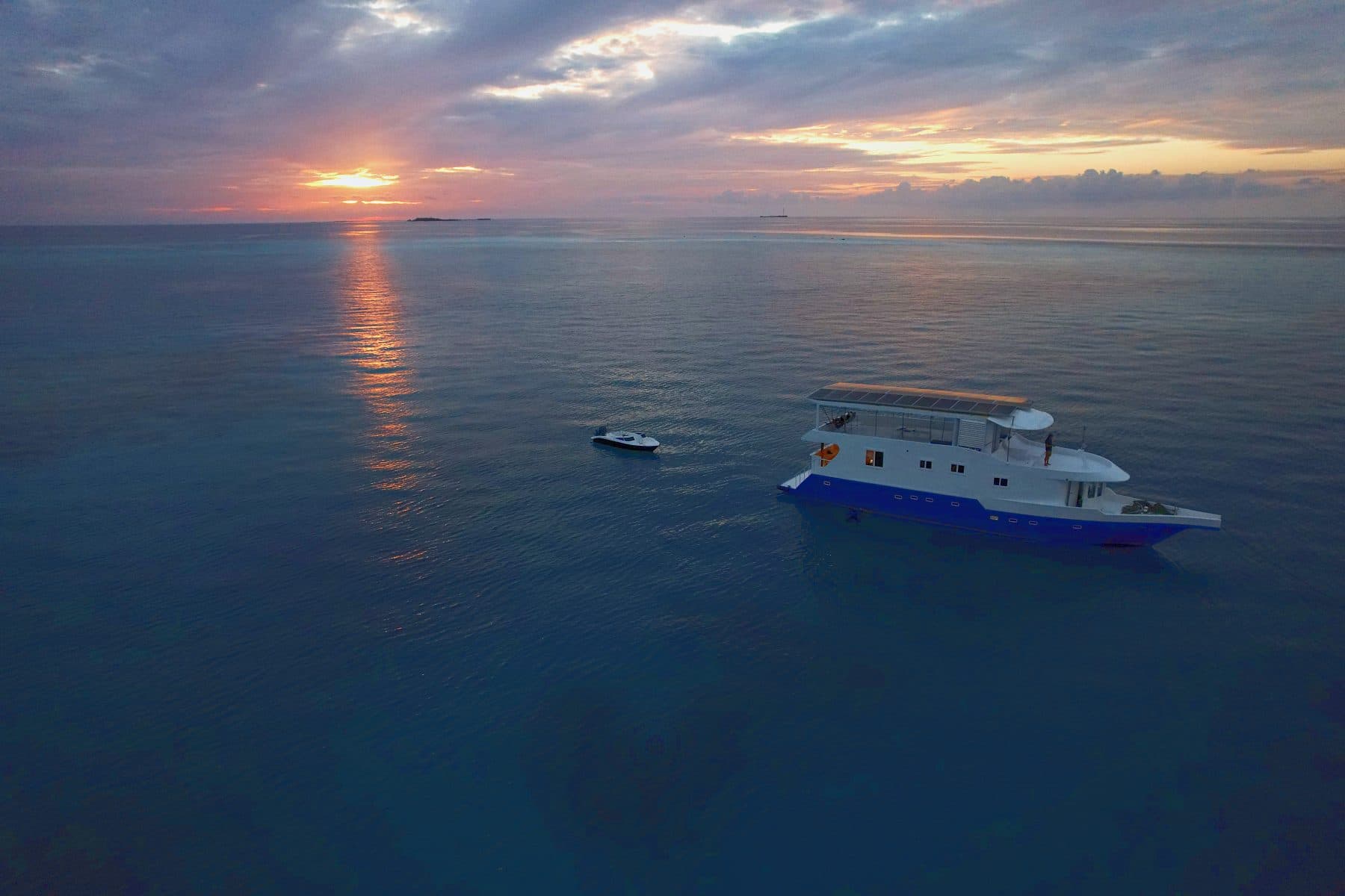NOAH at anchor under a Maldivian sunset
