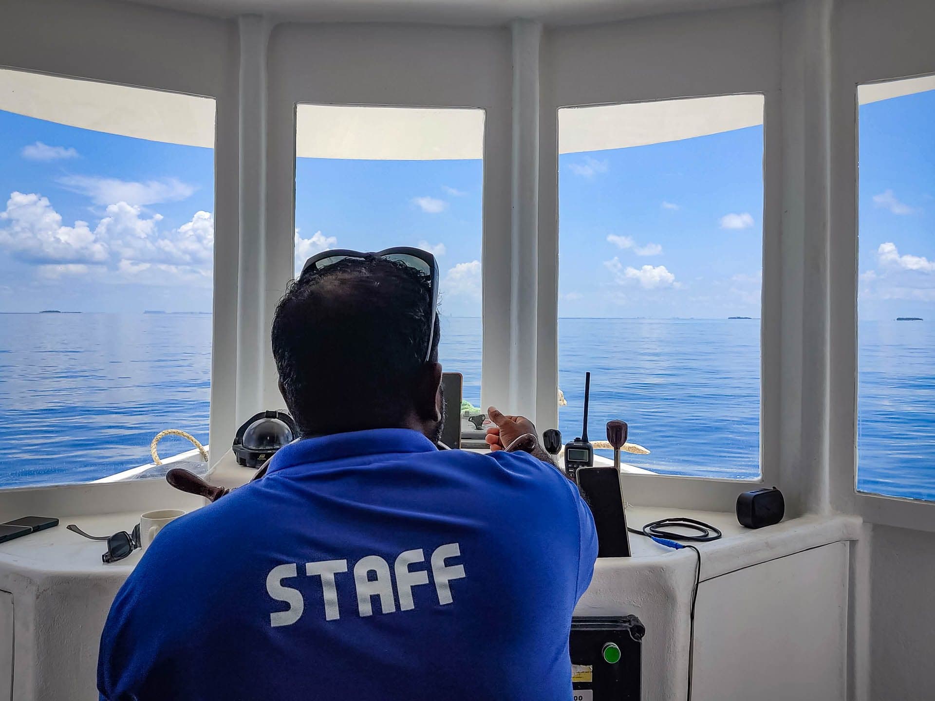 Captain Sunil in the wheelhouse, with panoramic sea views