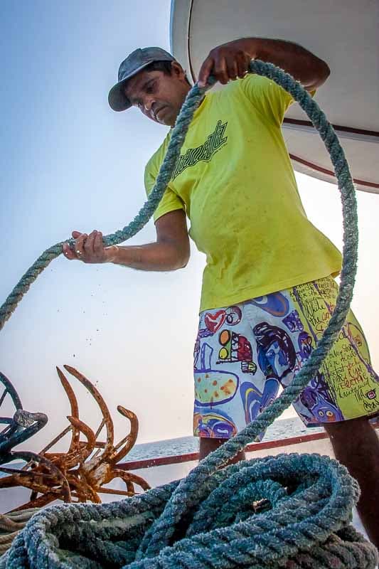 Crew member coiling the anchor rope on NOAH's bow