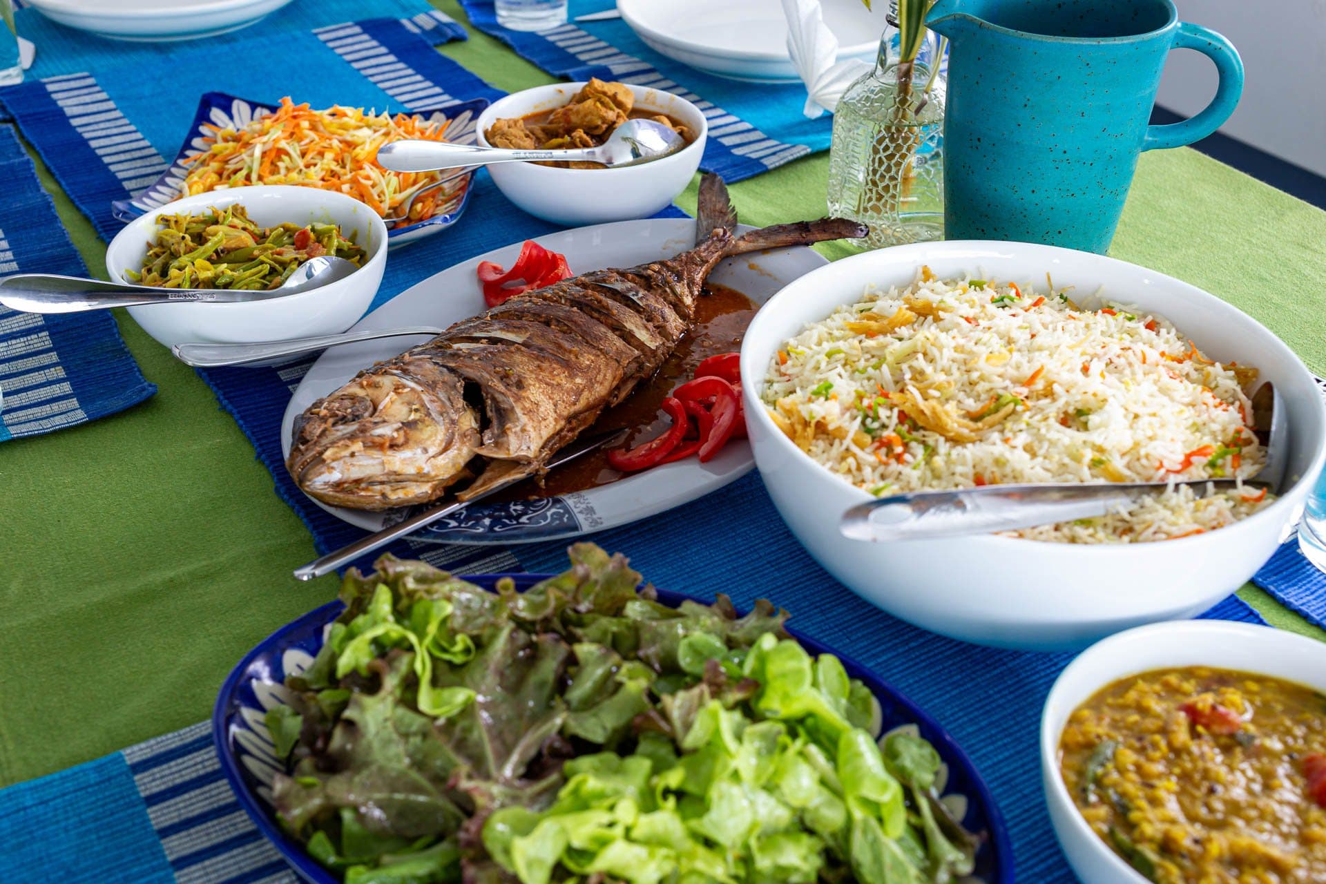 Grilled fish, rice, salad and dal laid out on the table on NOAH