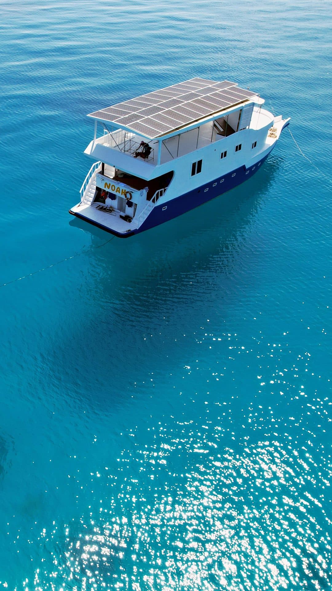 The NOAH safari boat at anchor in clear turquoise Maldivian water