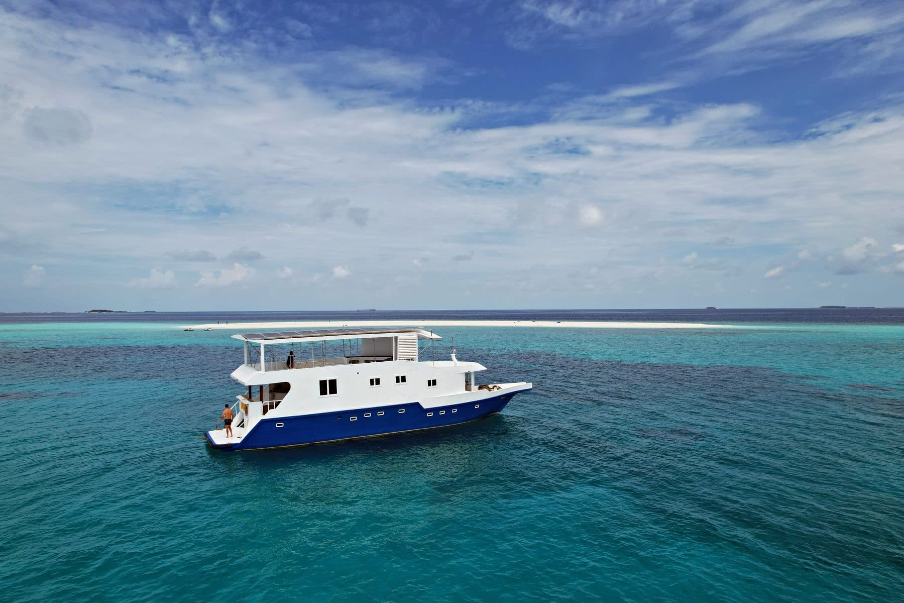 Guests on board NOAH anchored off a white sandbank