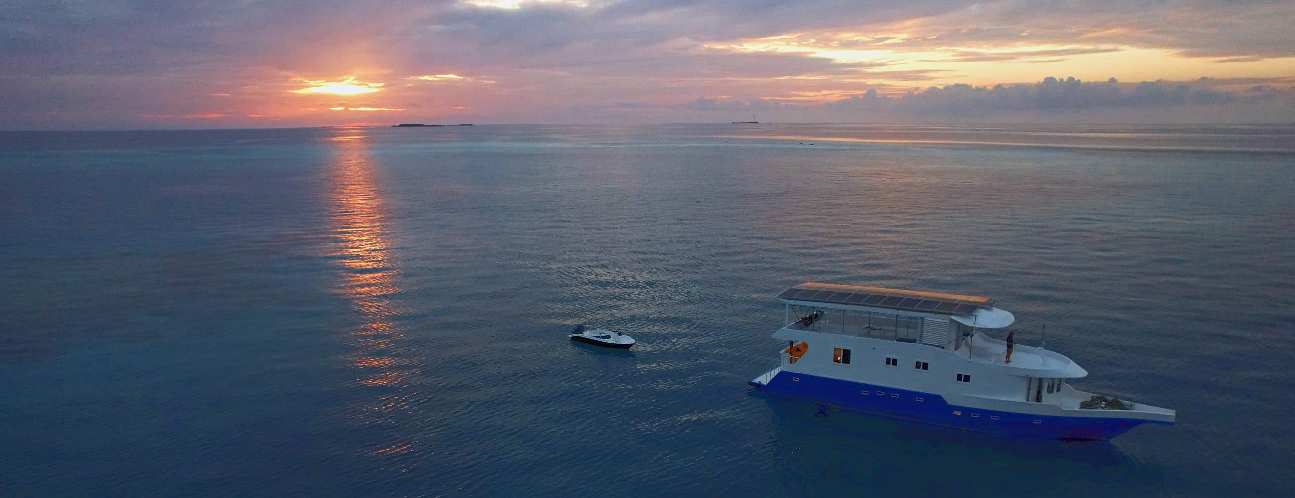 The NOAH safari boat at anchor under a Maldivian sunset